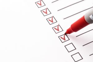 red-pen-checking-off-items-on-a-checklist