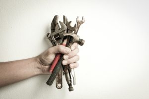 hand-holding-old-tools